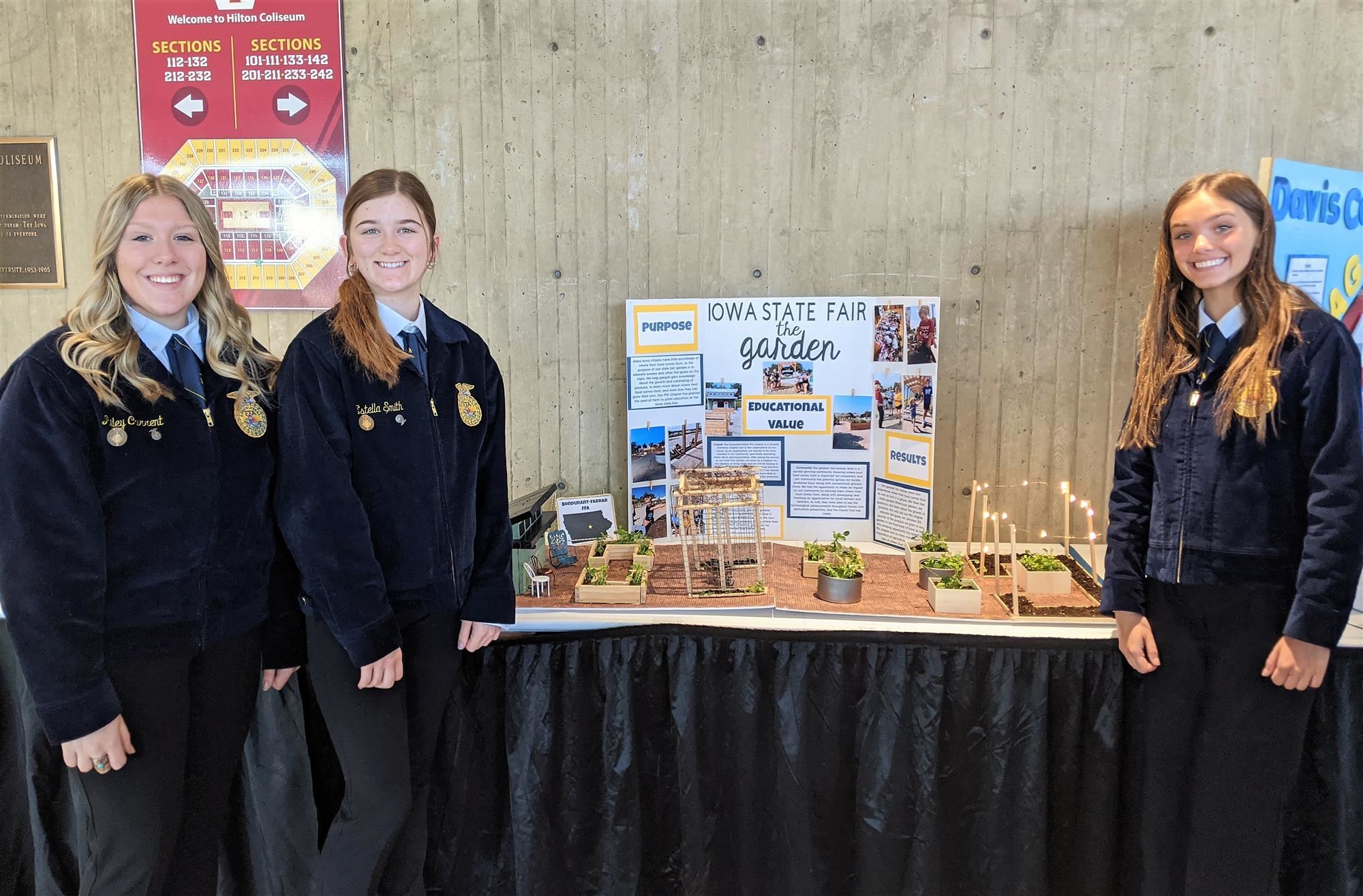 chapter display team members standing with exhibit